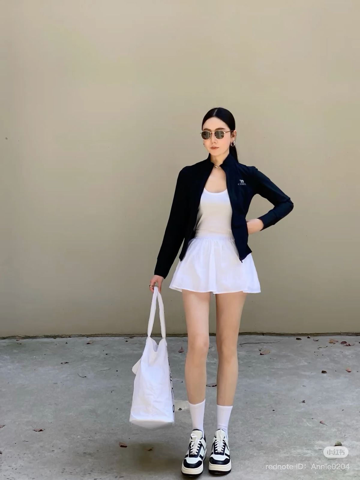 Áo khoác len mỏng, chân váy tennis, sneaker, athleisure dạo phố.